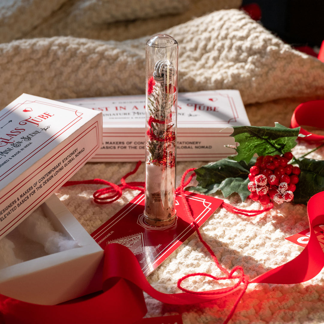 Decorative glass tube with a christmas mis-en-scene